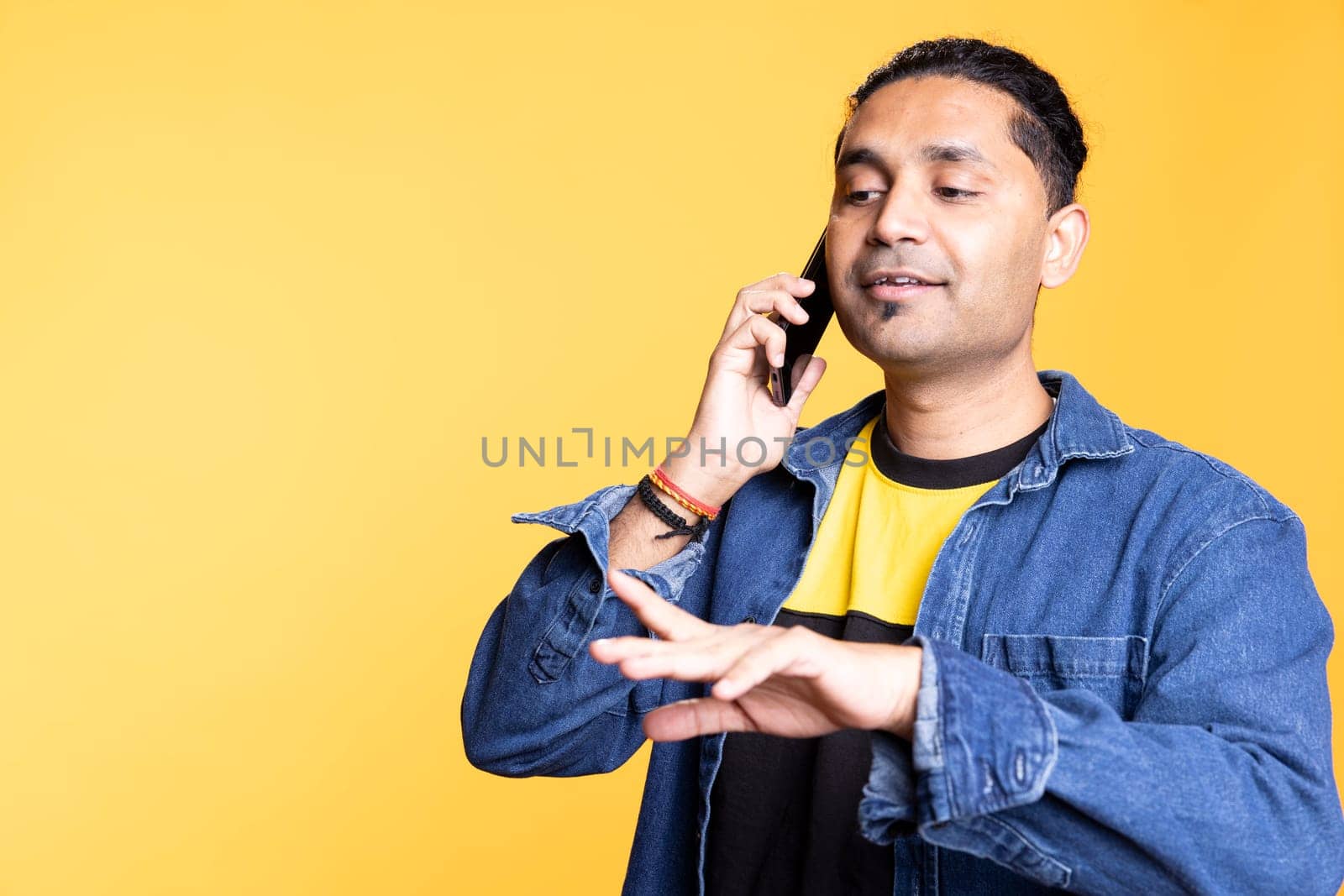 Happy person in casual outfit chatting with best friend over telephone call, discussing with people and keeping in touch. Joyous guy in casual attire communicating with mate using phone.