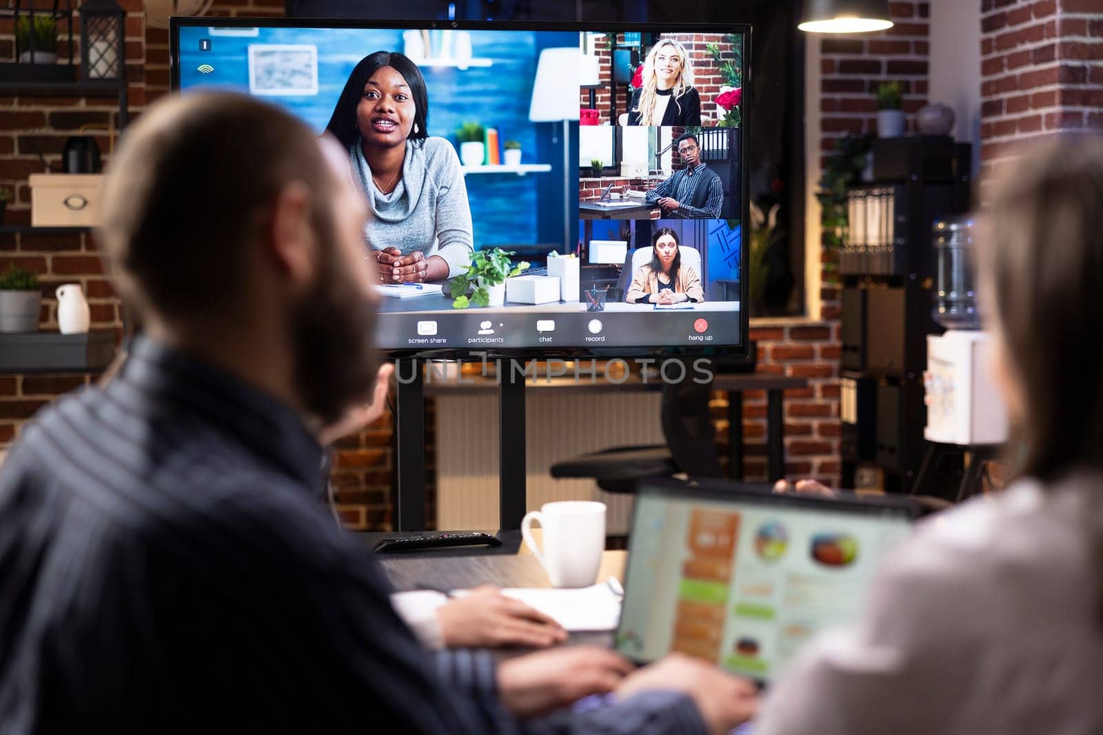 Professional businesswoman leading a remote team meeting to discuss marketing strategy and goals. Diverse professionals engage in virtual video call to share ideas and review project timelines.