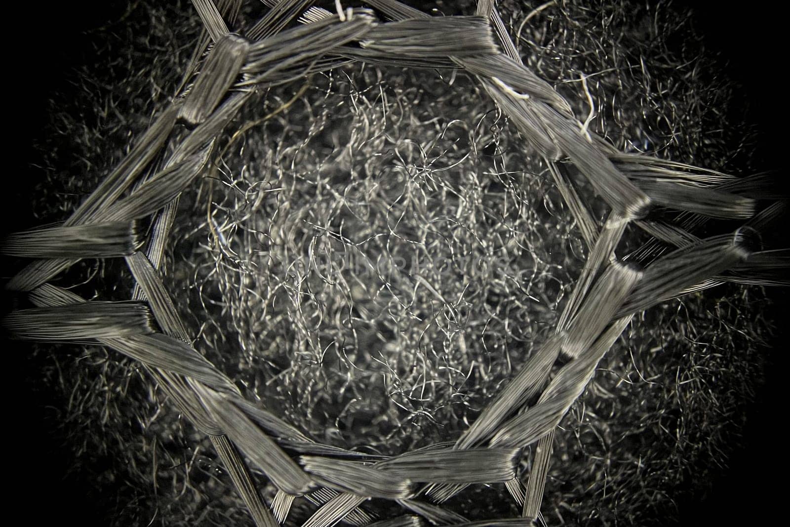 Intricate microscopic image revealing the detailed structure of fabric fibers, emphasizing their texture and composition.