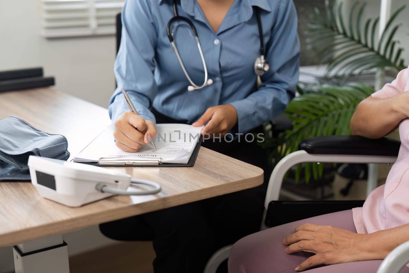 A doctor carefully records vital signs and health details during a routine consultation, prioritizing the patient's wellness and care.