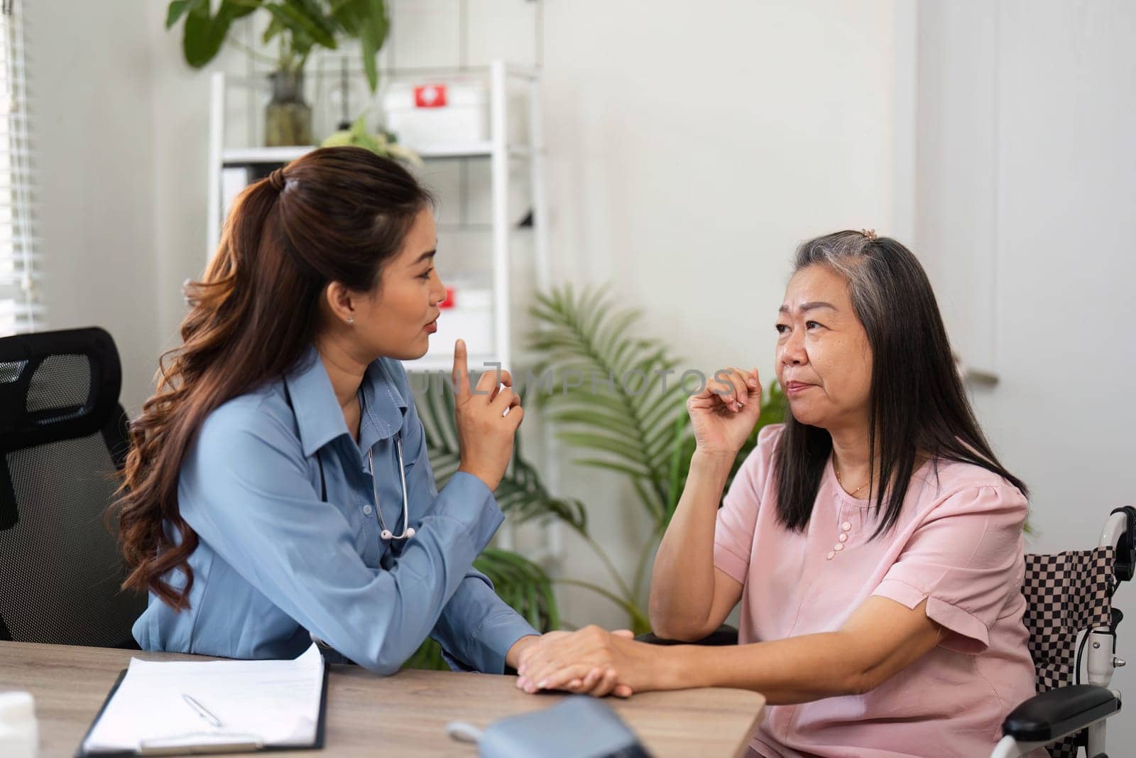In a calming setting, the nurse advises the elderly woman, emphasizing clear communication and understanding during the consultation.