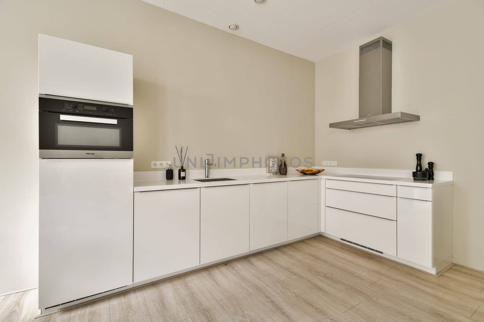 Sleek and contemporary kitchen featuring white cabinets, stainless steel appliances, and a clean layout that enhances functionality and aesthetics.