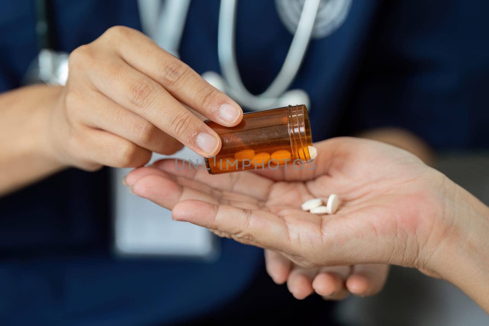 The caregiver assists a senior patient in managing medications, emphasizing the importance of correct dosage and timing for health.