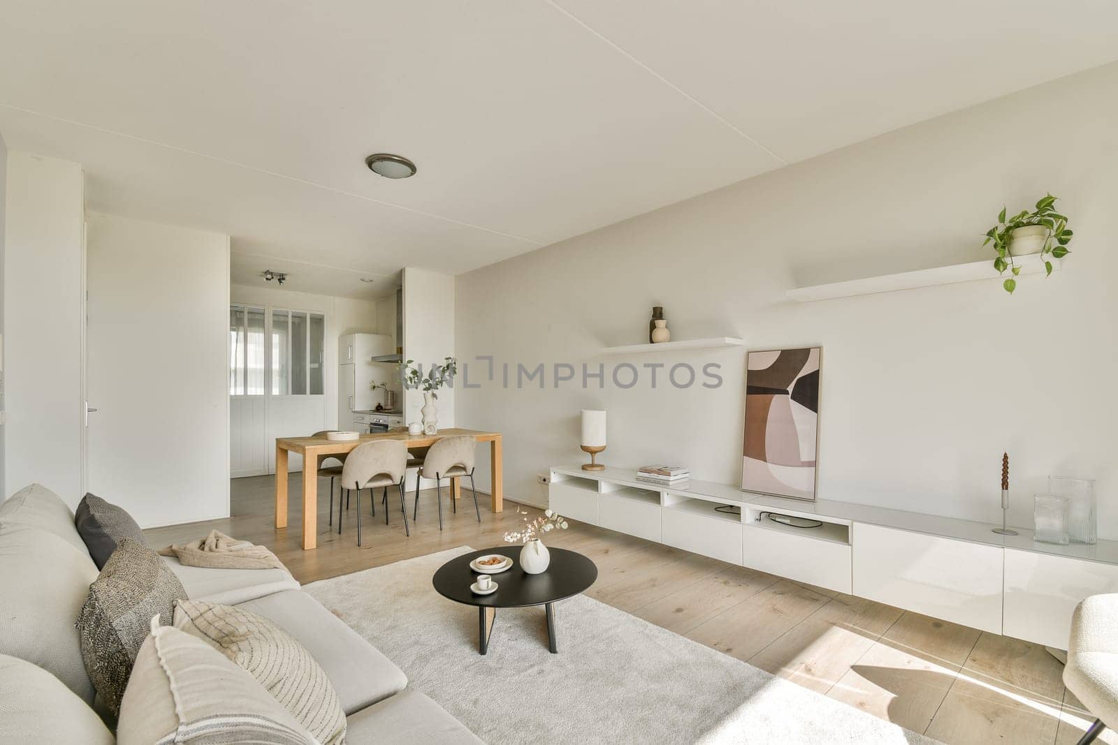 Minimalist modern living room featuring neutral tones, stylish furniture, and a cozy atmosphere that encourages relaxation and comfort in a contemporary setting.