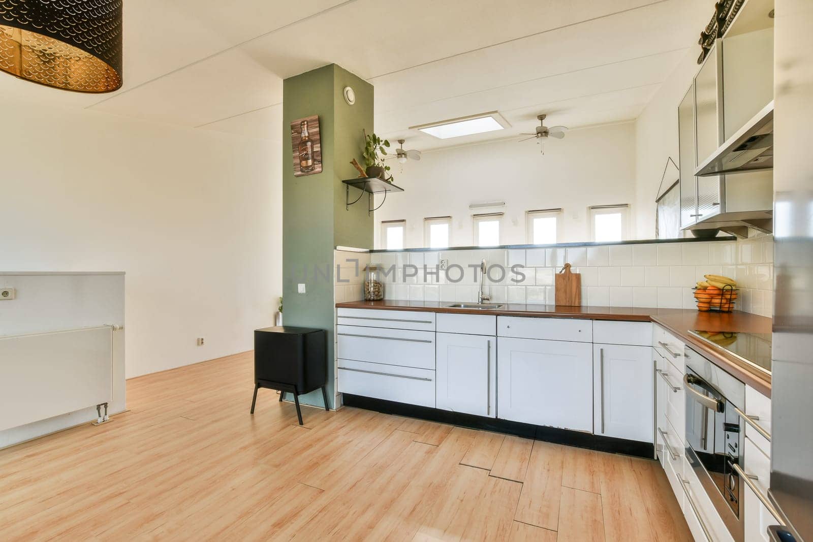 Bright and airy modern kitchen featuring a sleek design with wooden accents, ample storage, and contemporary appliances for a functional cooking space.