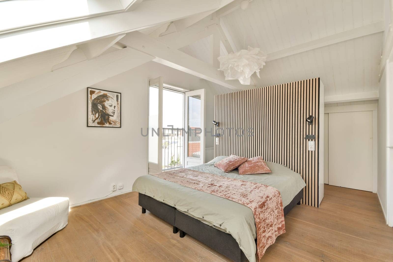 Stylish bedroom featuring a combination of light-colored walls, elegant bedding, and a unique art piece. The space embodies a contemporary minimalist design philosophy.