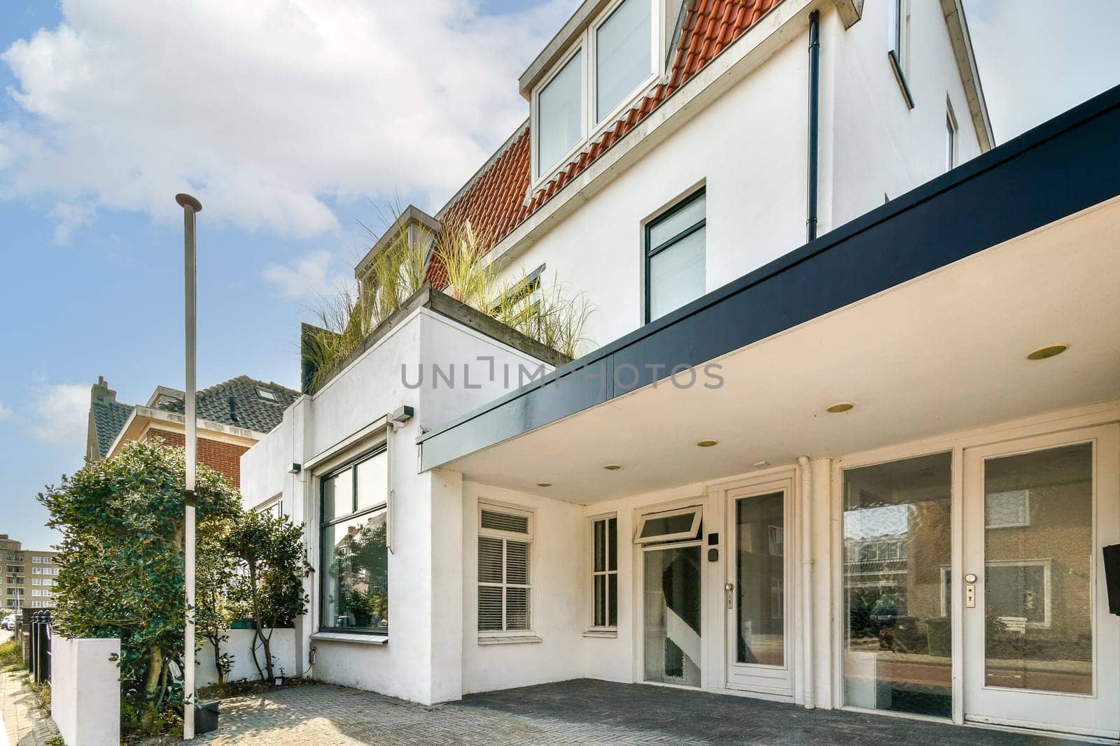 Contemporary architecture featuring a stylish facade and landscaped surroundings in a vibrant urban setting, showcasing modern living spaces.