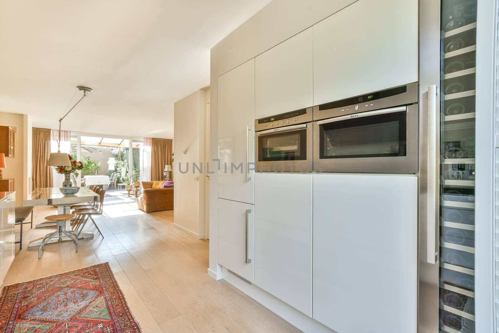A sleek modern kitchen featuring built-in appliances, minimalist cabinetry, and an open layout connecting to the living space, perfect for entertaining guests.