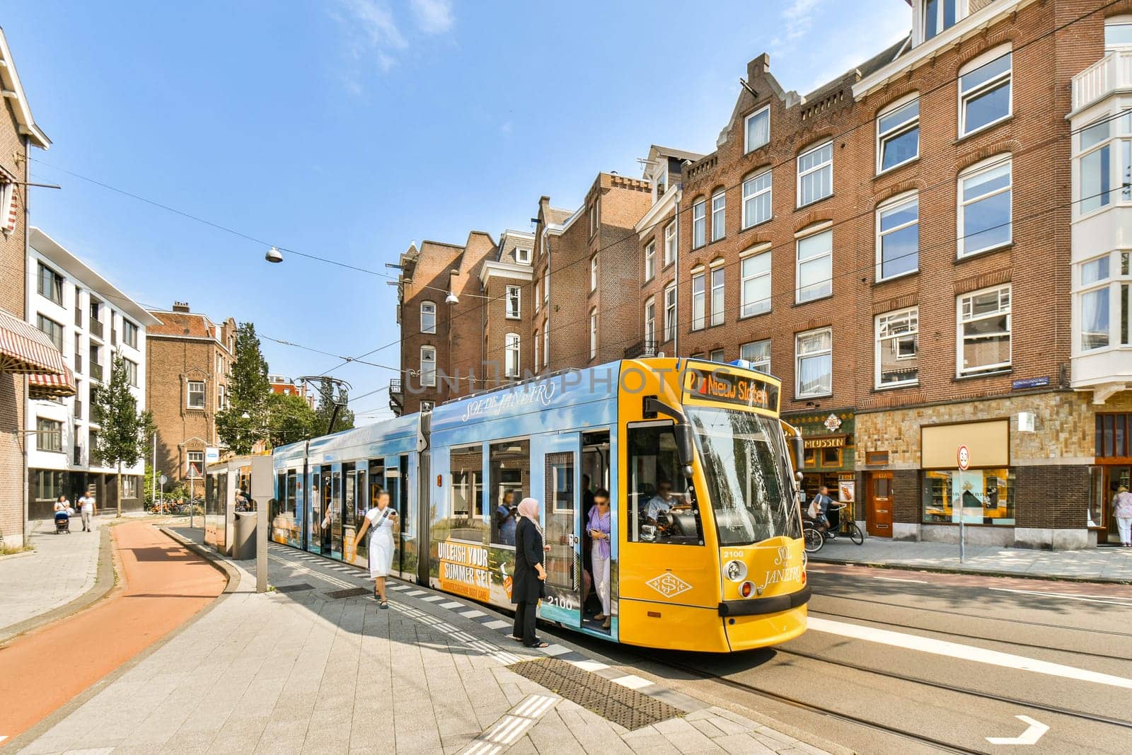 A vibrant tram making its way through a bustling city street lined with historic buildings, showcasing daily urban life and transport.