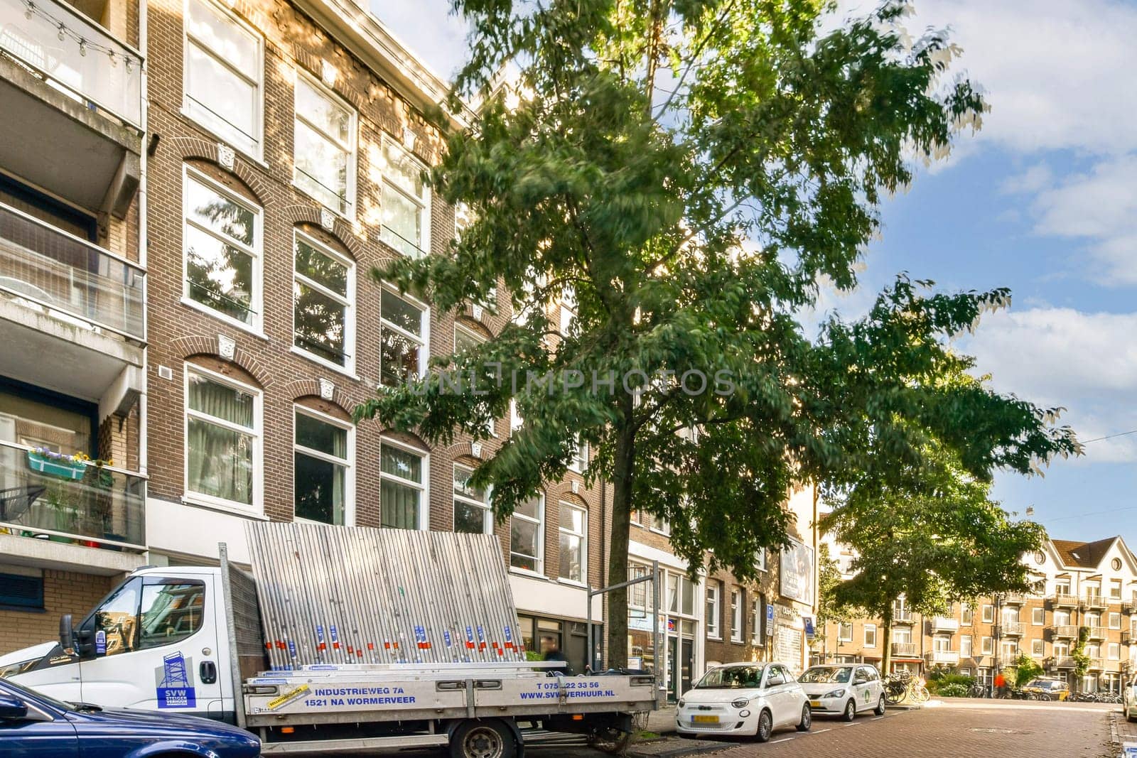 A vibrant urban street scene featuring a stately building, lush trees, and parked vehicles, depicting the harmony of nature and city life.
