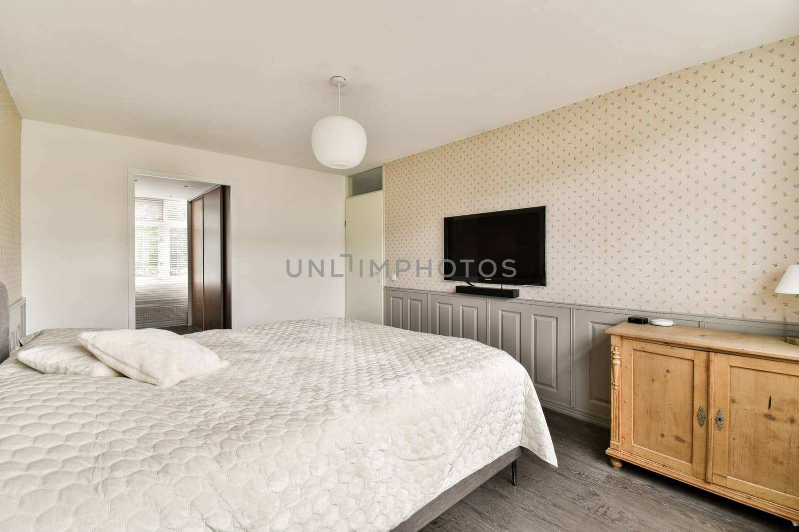 A stylish modern bedroom featuring a minimalist design with light colors, a cozy bed, and contemporary furniture, creating a serene atmosphere.