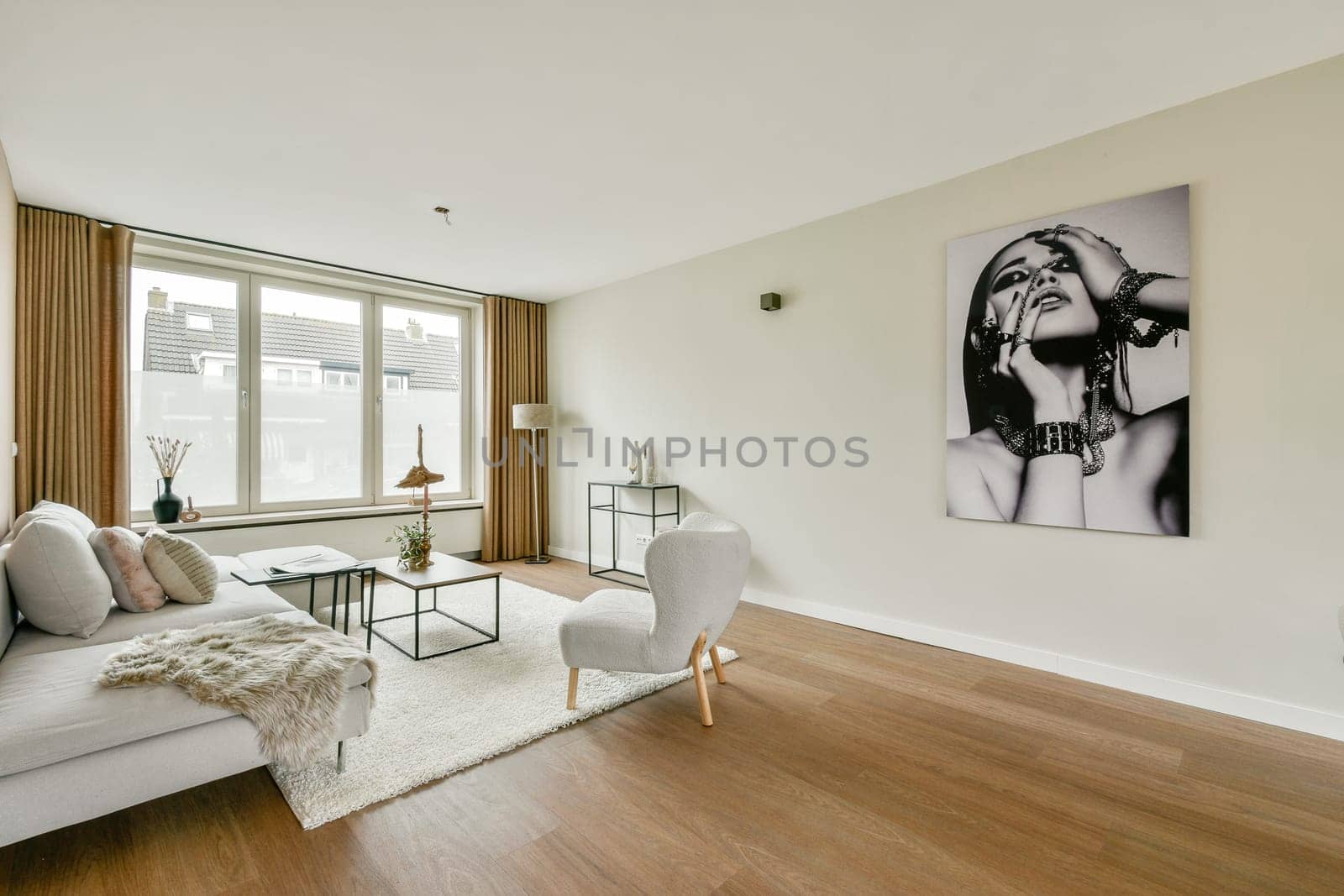 A stylish modern living room featuring a chic sofa, elegant decor, and an eye-catching wall art piece, creating a cozy and inviting atmosphere.