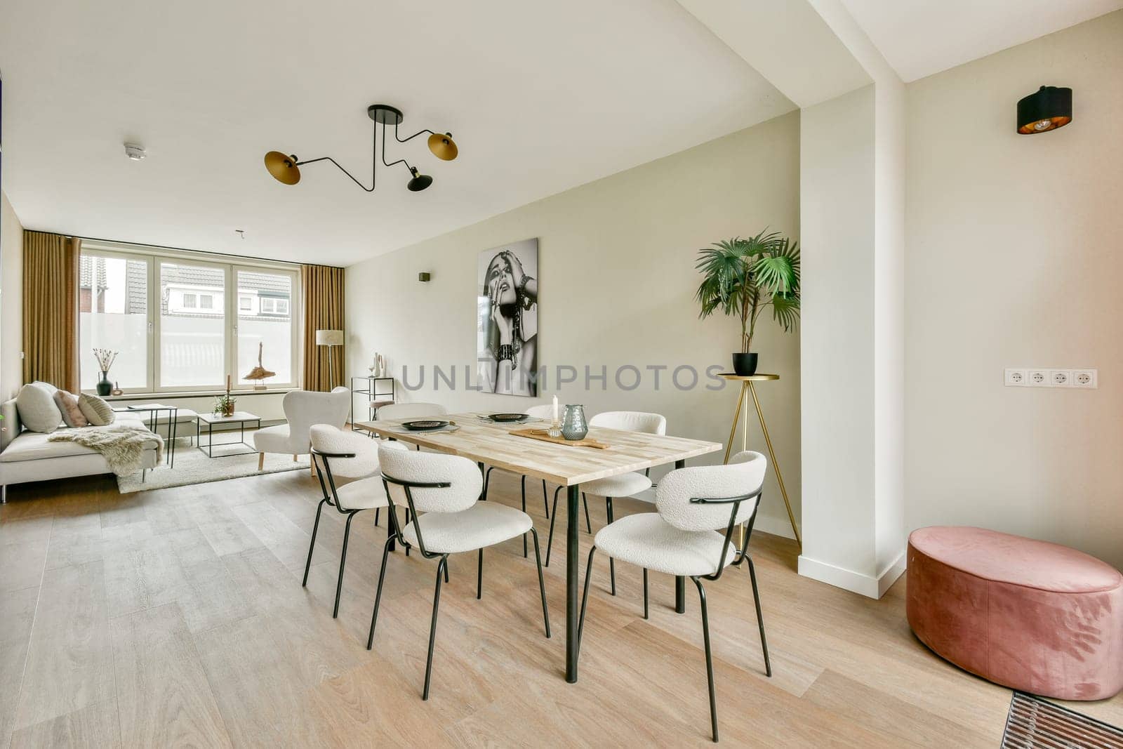A stylish modern living room featuring elegant furnishings, ample natural light, and a serene color palette that creates a welcoming atmosphere.