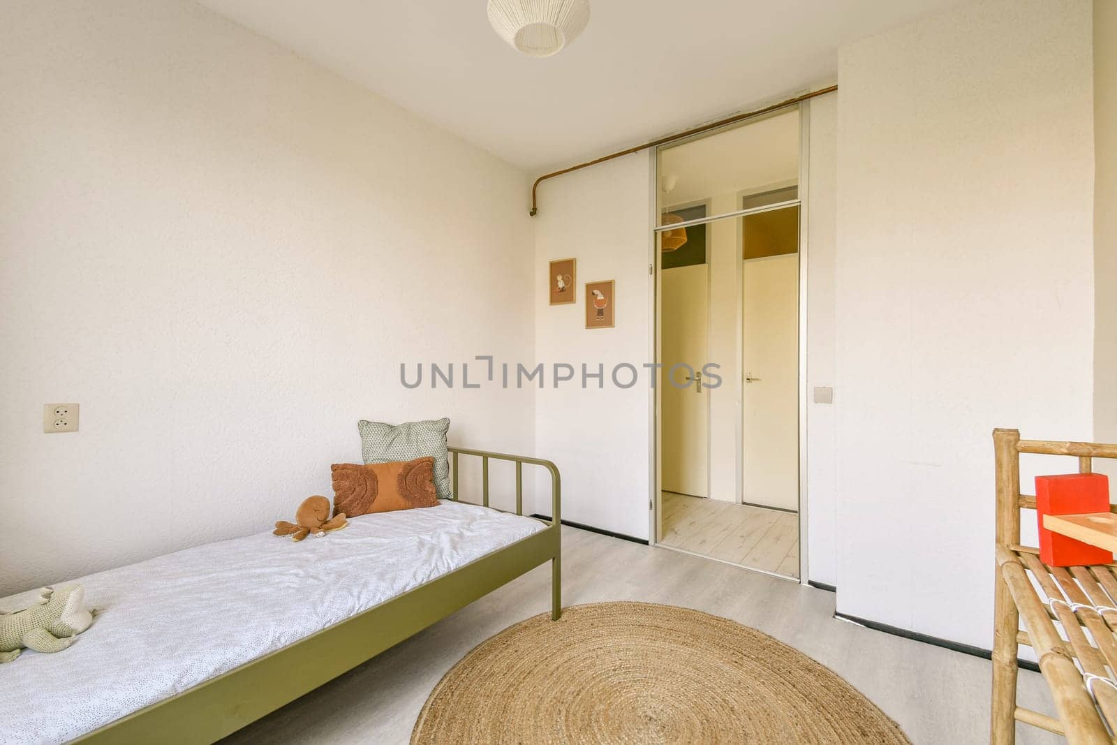 A cozy and minimalistic bedroom featuring a simple bed, soft textiles, and a warm color palette, highlighting modern decor elements.