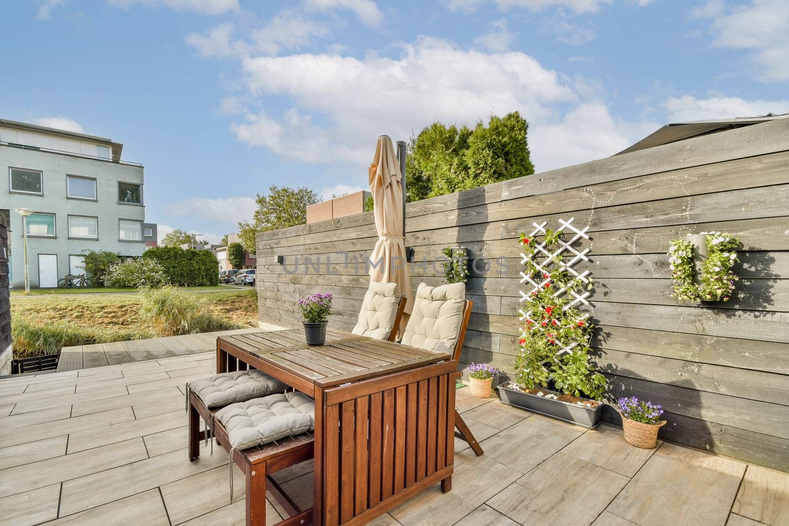 A luxurious outdoor terrace featuring stylish furniture, plants, and a serene atmosphere, perfect for relaxation and gatherings.