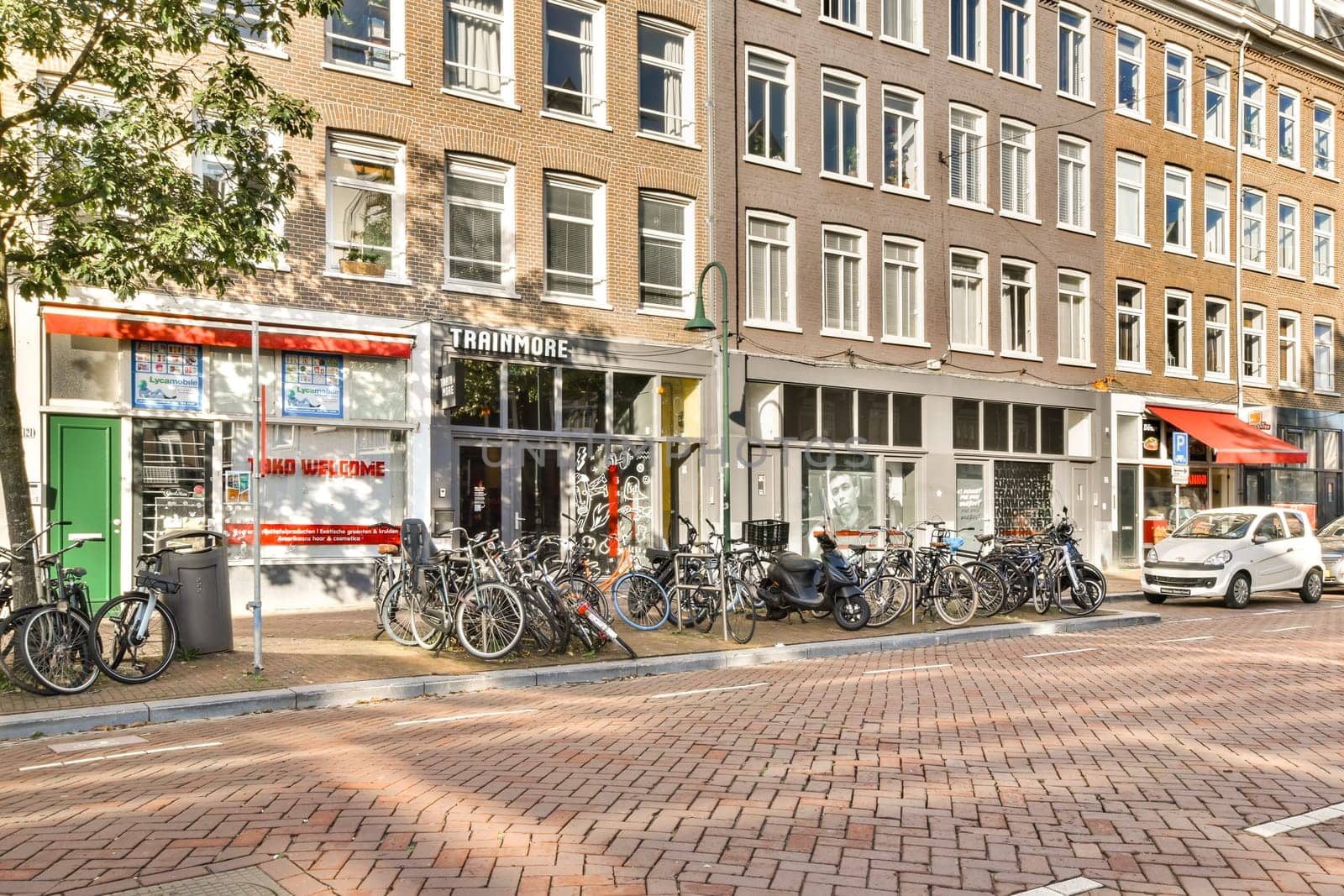 A picturesque urban street featuring vintage buildings, parked bicycles, and a vibrant atmosphere, perfect for showcasing city life and culture.