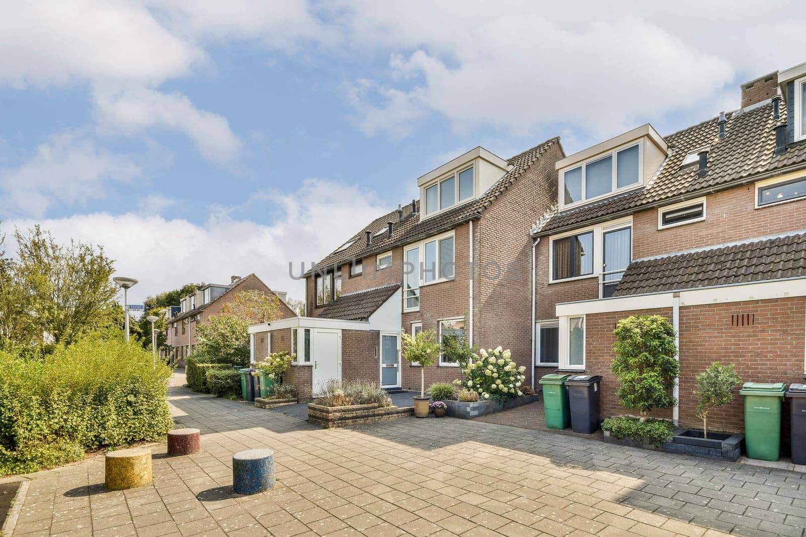 A picturesque residential area featuring modern homes, well-maintained gardens, and a clean, inviting pathway. Ideal for families and outdoor enthusiasts.