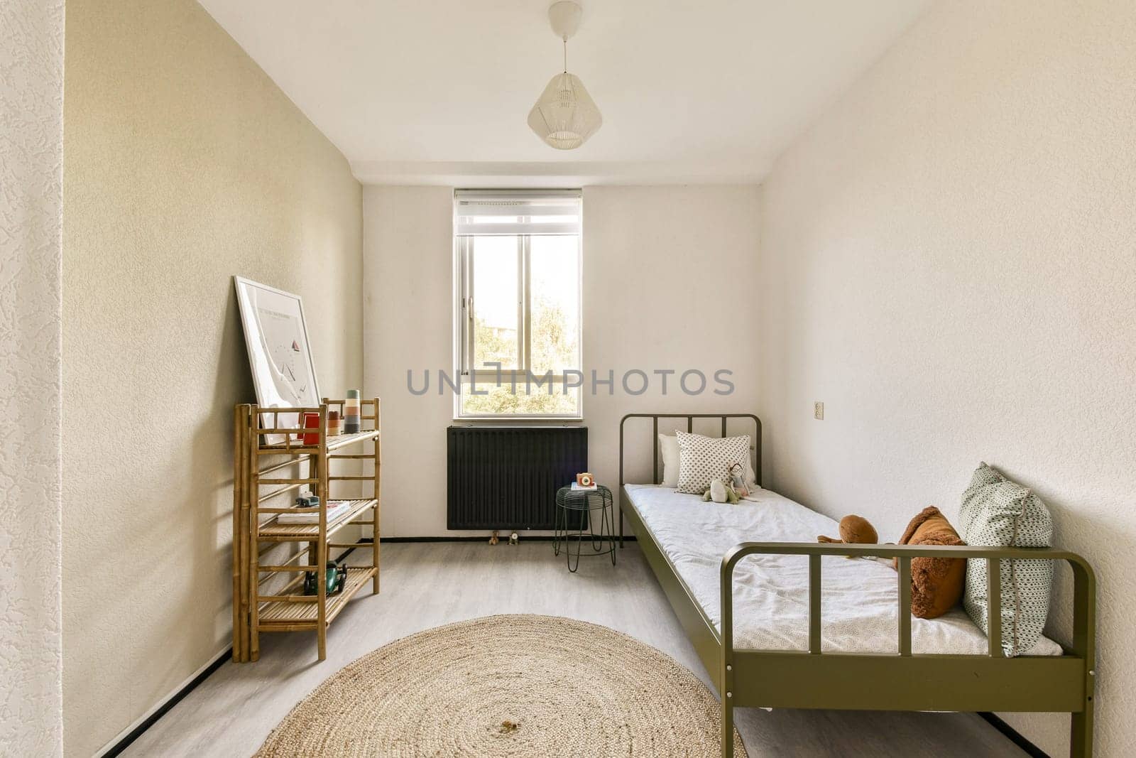 A serene and well-lit minimalist bedroom featuring a single bed, decorative items, and natural light filtering through a window.