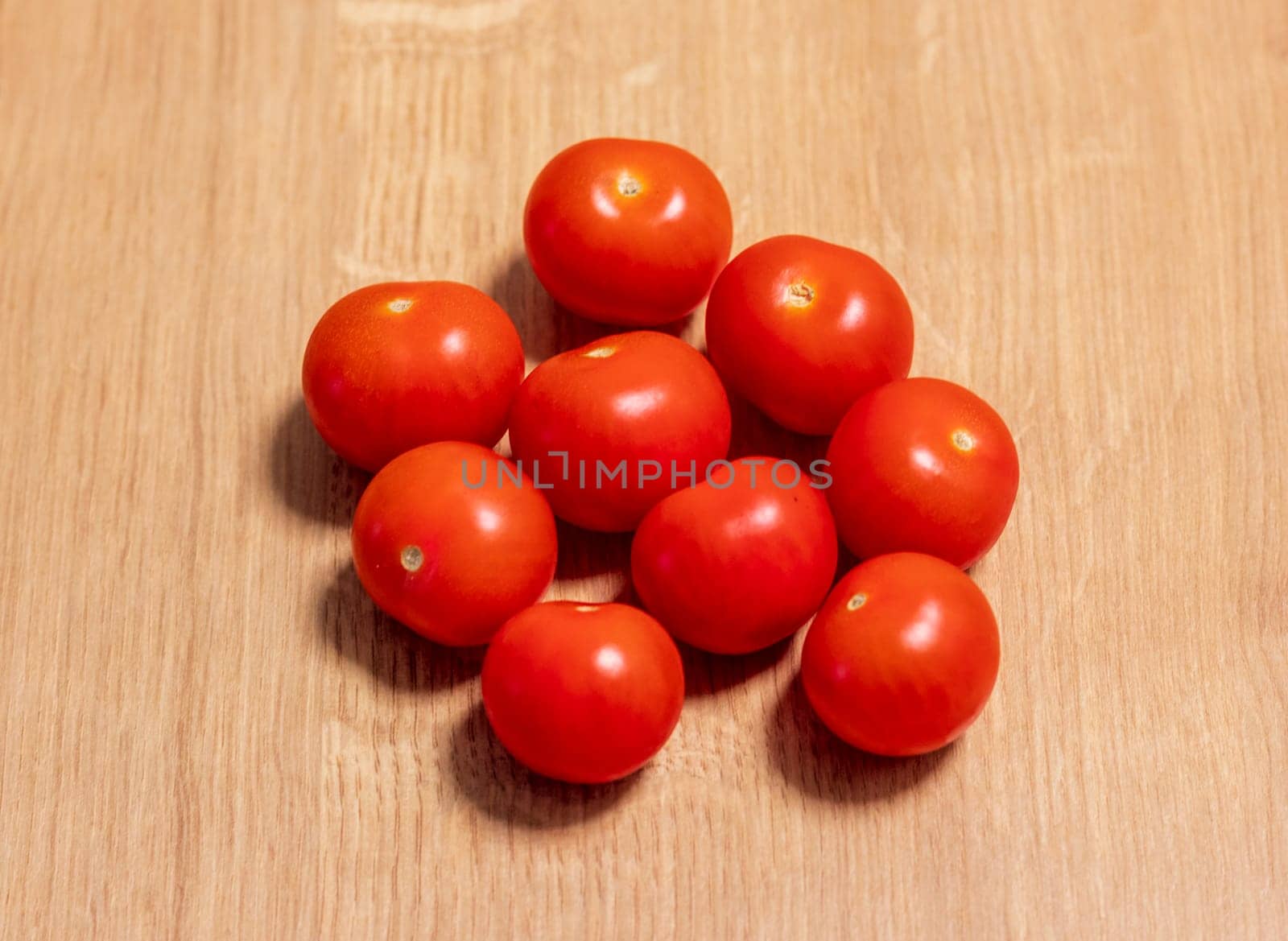 Cherry tomatoes on the wooden surface