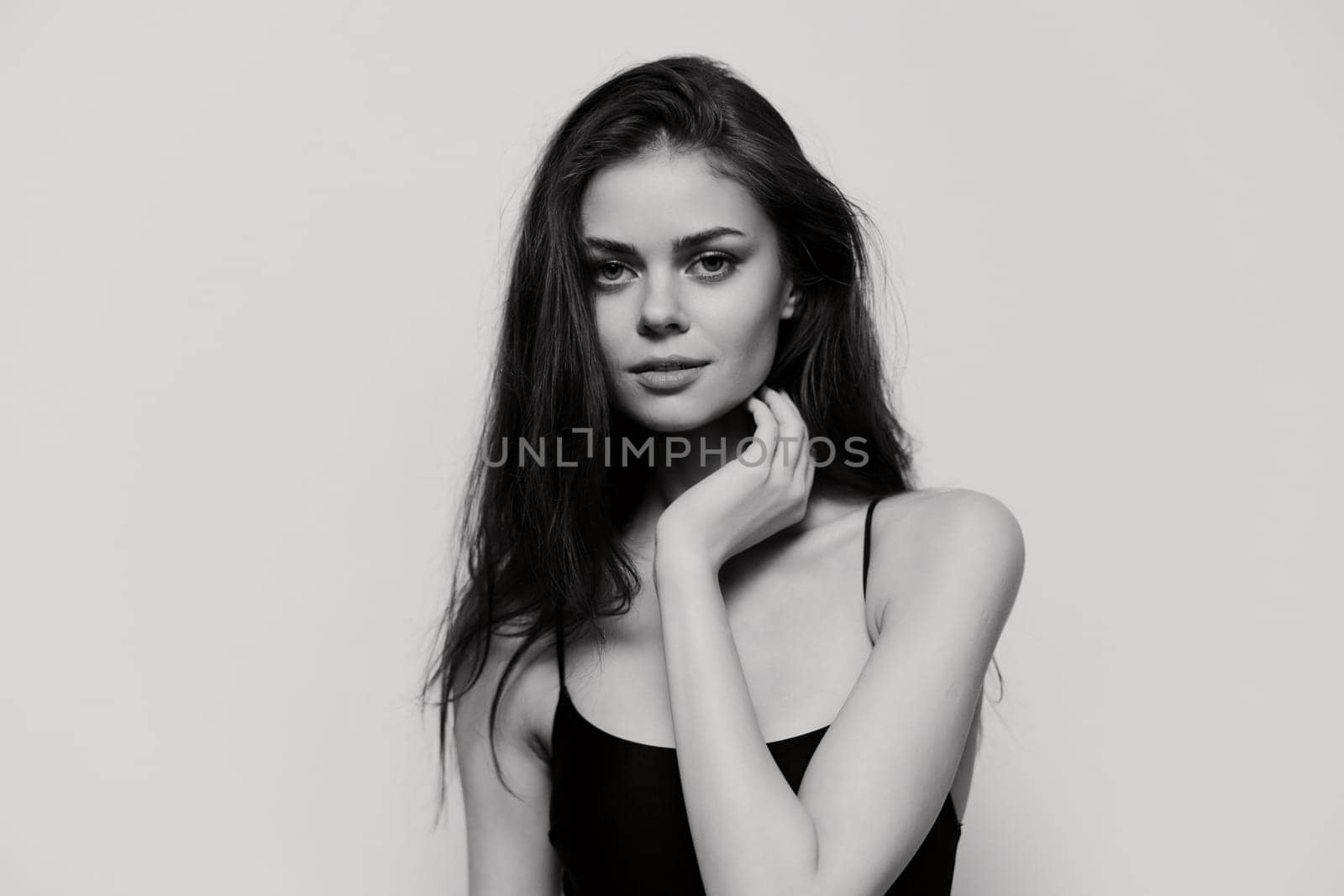 A stunning black and white portrait showcasing a young woman's serene expression, highlighting her beauty and confidence, perfect for beauty and fashion concepts.