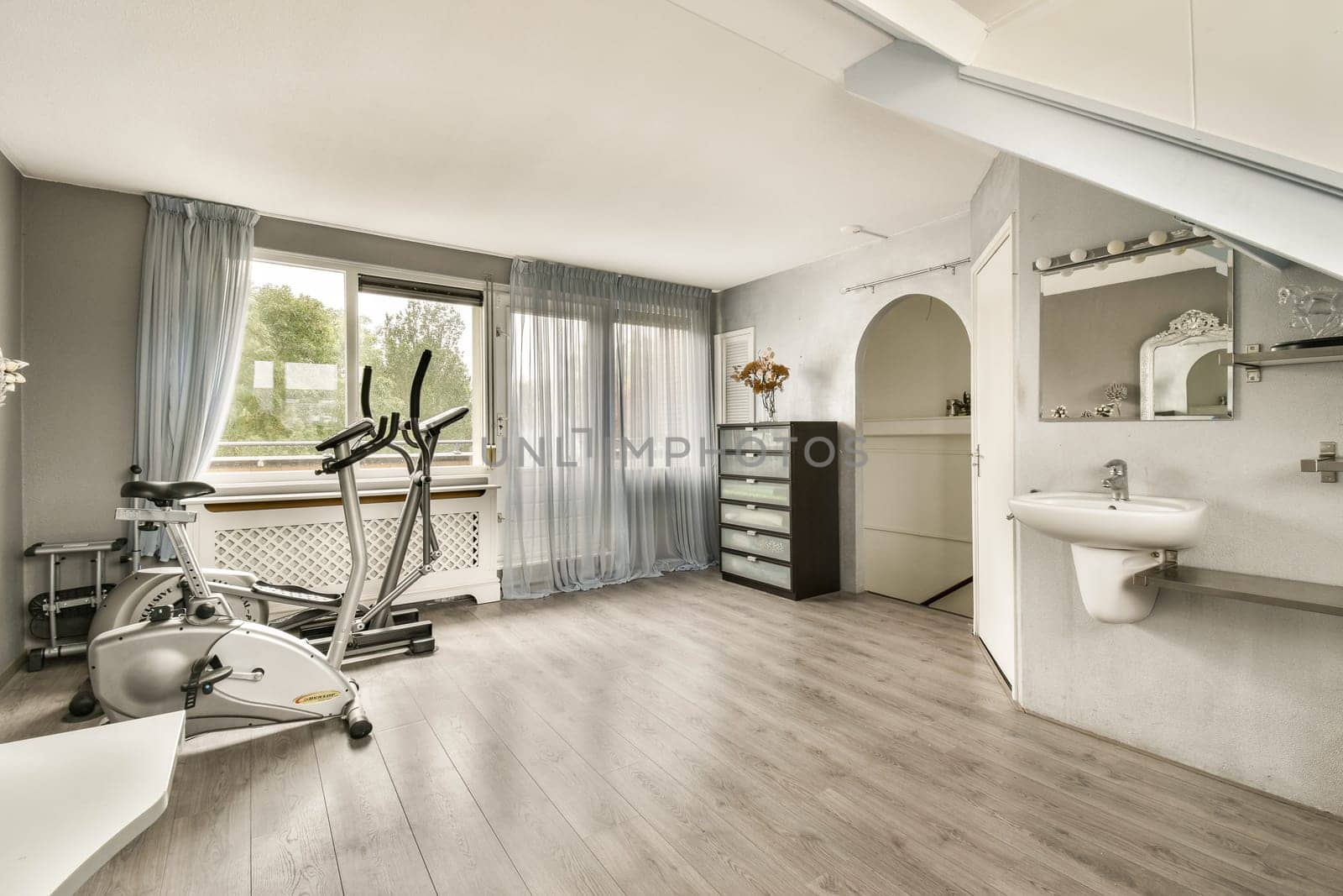 A contemporary home gym space featuring exercise equipment, natural light, and sleek design elements, creating an inviting atmosphere for fitness activities.