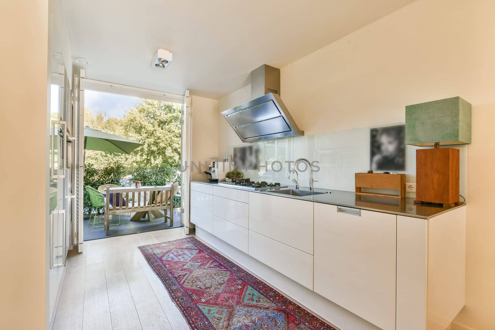 A stylish modern kitchen featuring sleek cabinetry, a functional layout, and large windows offering a view of an inviting outdoor space. A perfect blend of design and utility.