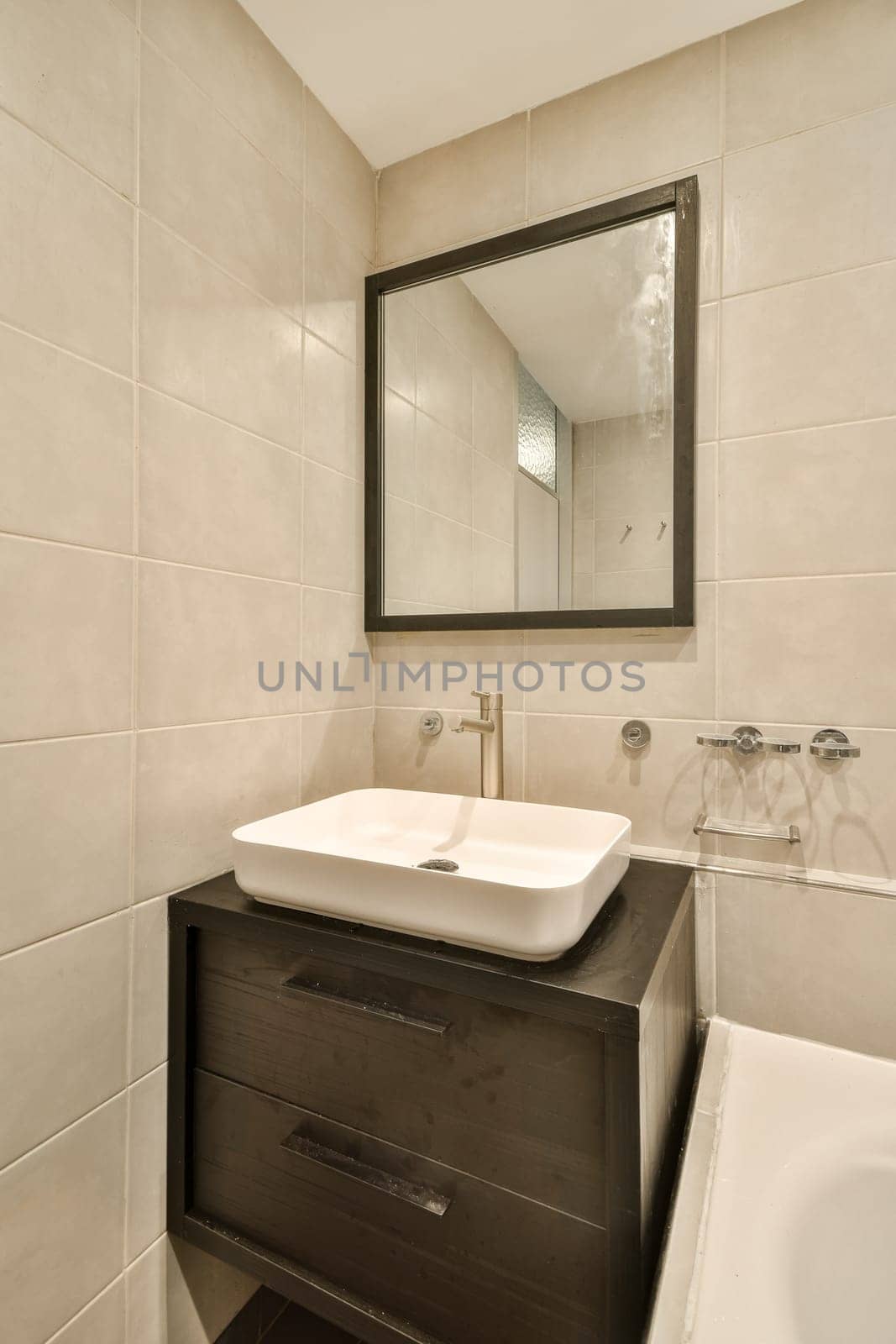 A sleek and contemporary bathroom featuring stylish fixtures and a minimalist design. The space includes a mirror and a convenient sink area for everyday use.