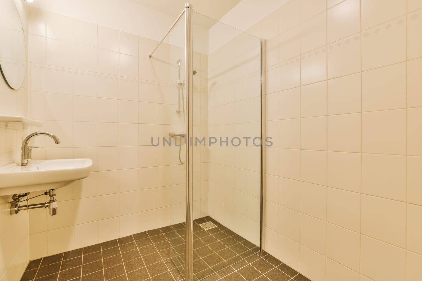 Sinks with mirrors and shower box with glass door in modern bathroom with white tiled walls