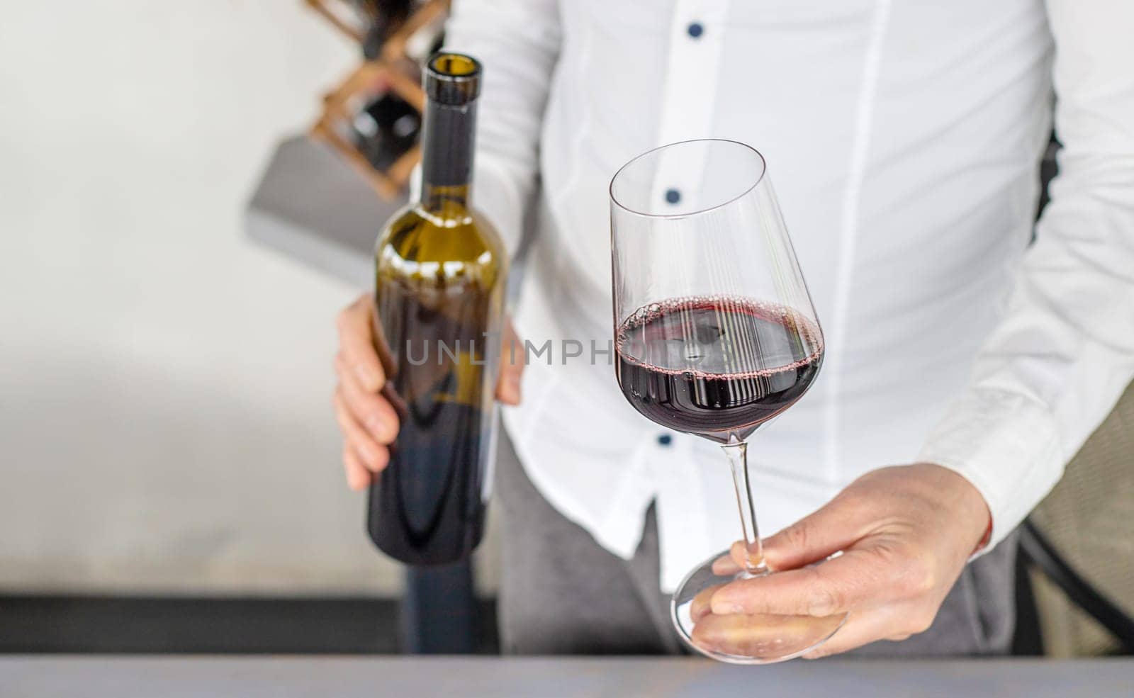 Glass of red wine in hands. Selective focus. drink.