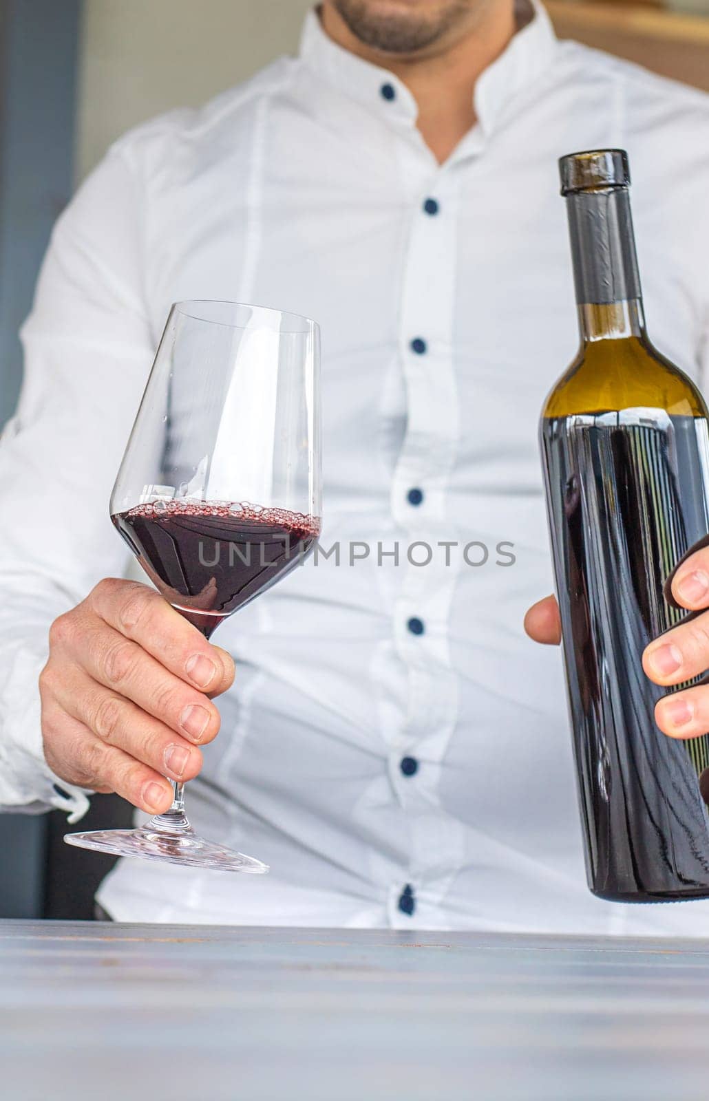 Glass of red wine in hands. Selective focus. drink.