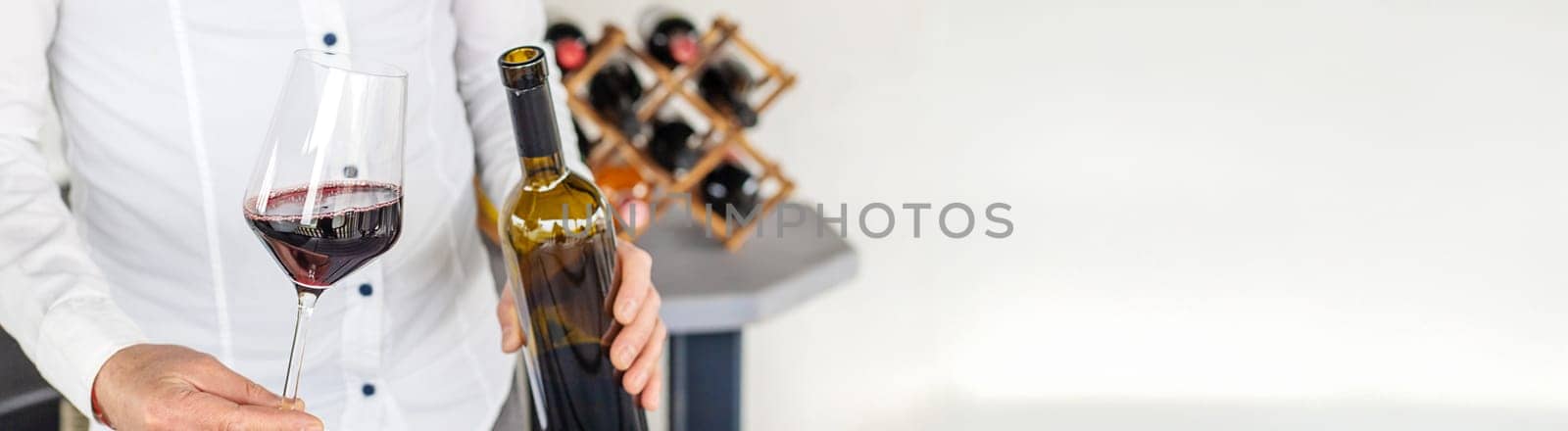 Glass of red wine in hands. Selective focus. drink.