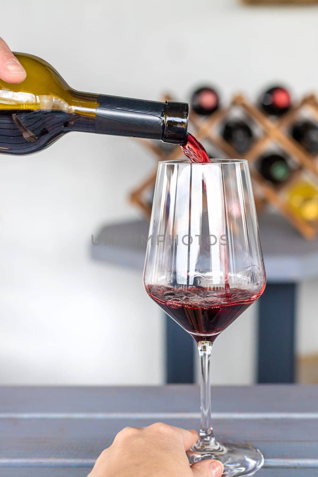 Glass of red wine in hands. Selective focus. drink.