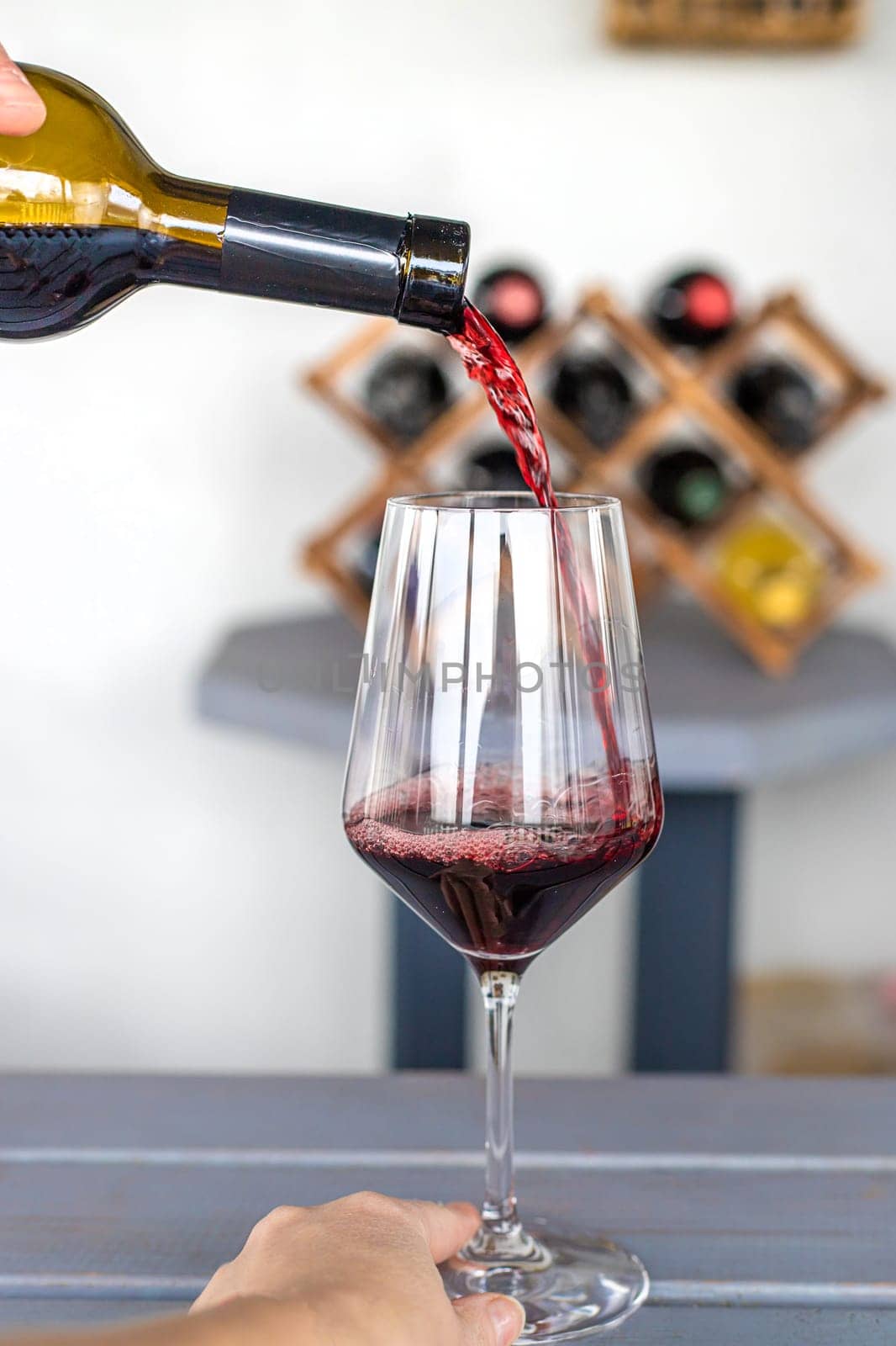 Glass of red wine in hands. Selective focus. drink.