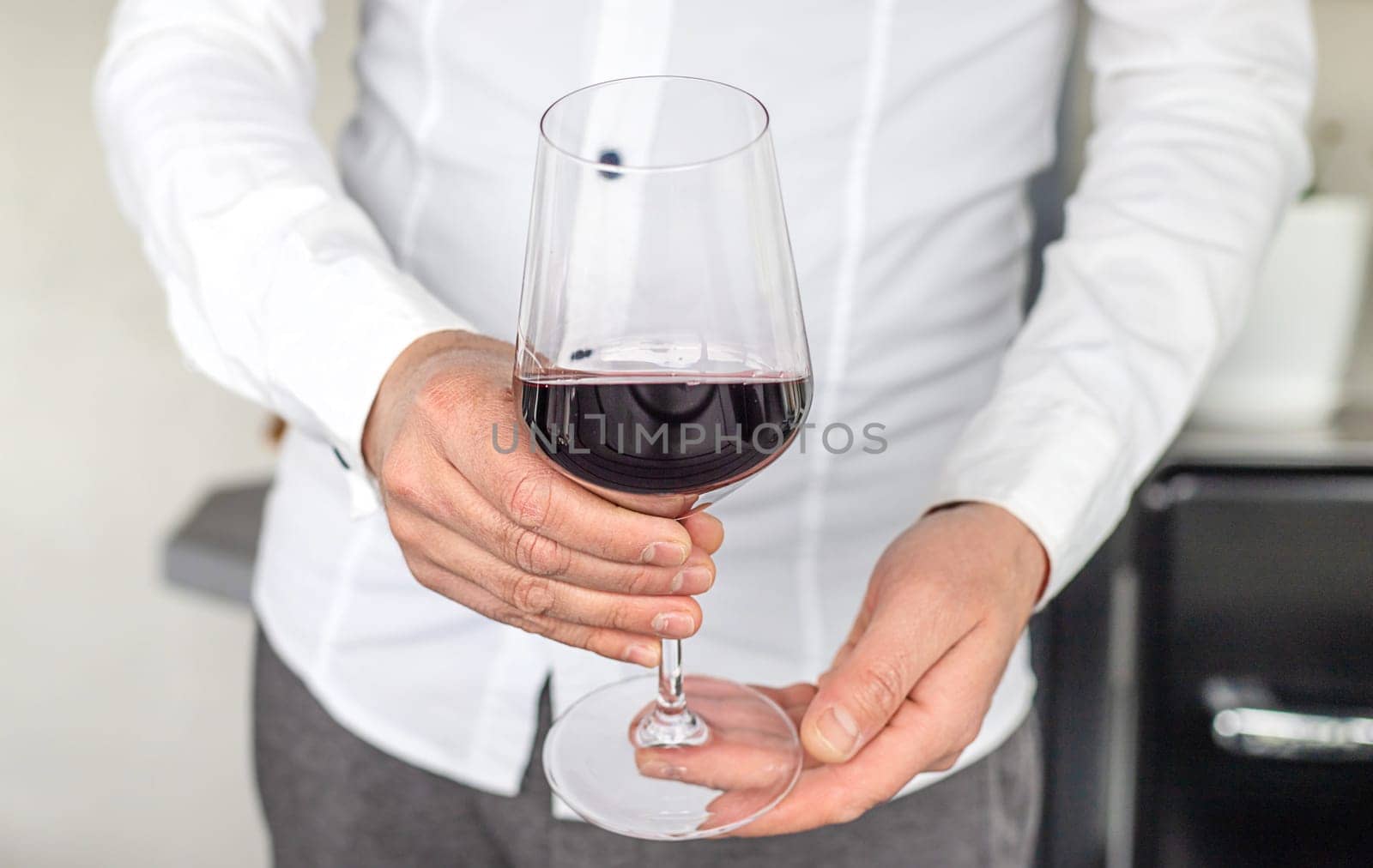 Glass of red wine in hands. Selective focus. drink.