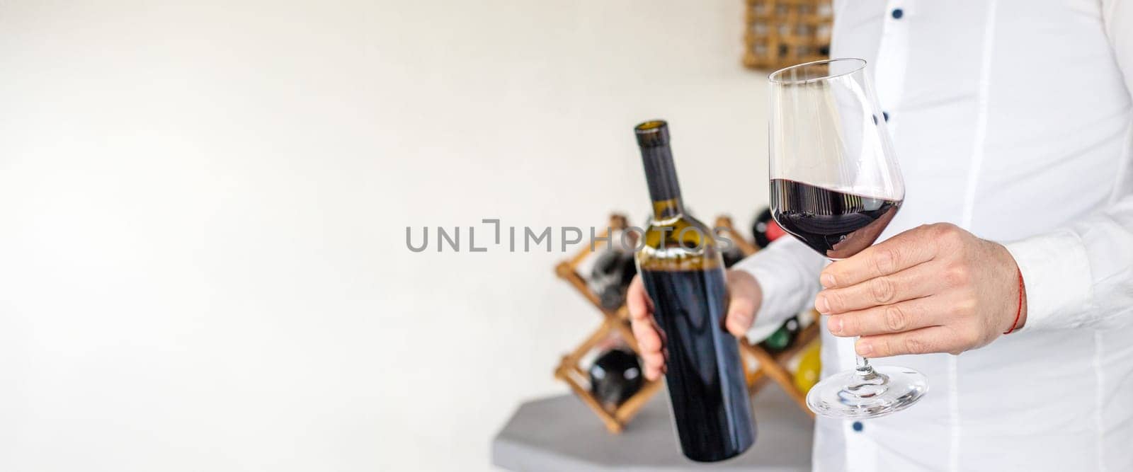 Glass of red wine in hands. Selective focus. drink.