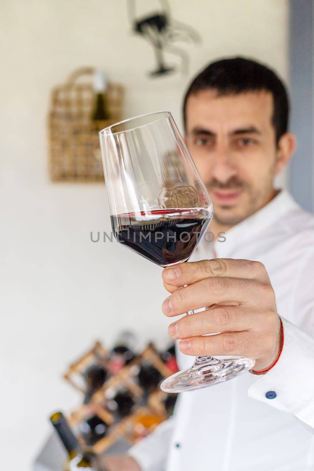 Glass of red wine in hands. Selective focus. drink.