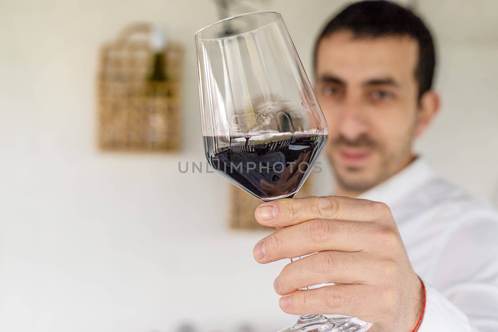 Glass of red wine in hands. Selective focus. drink.