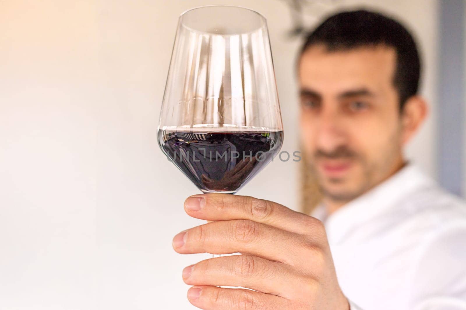 Glass of red wine in hands. Selective focus. drink.
