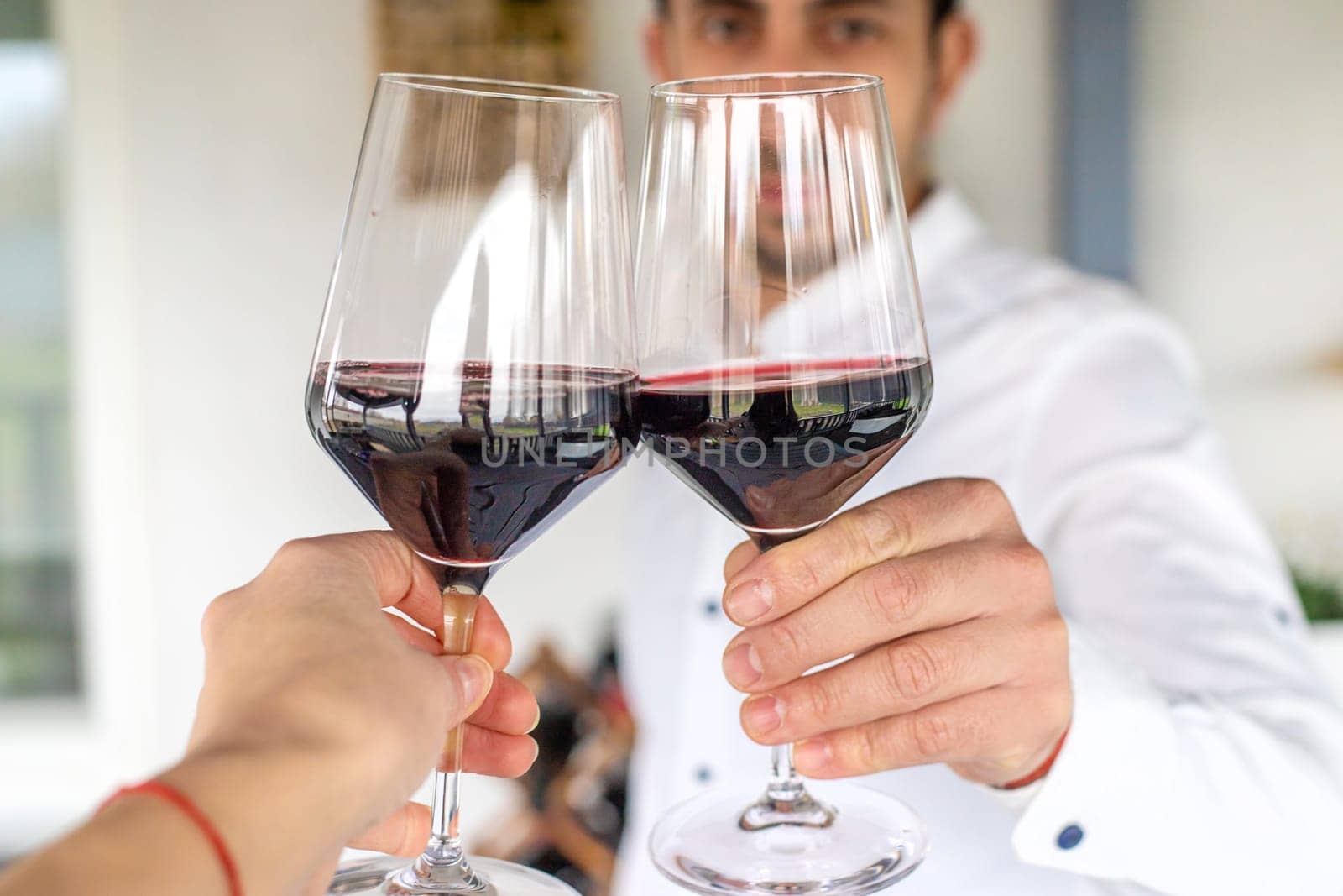 Glass of red wine in hands. Selective focus. drink.