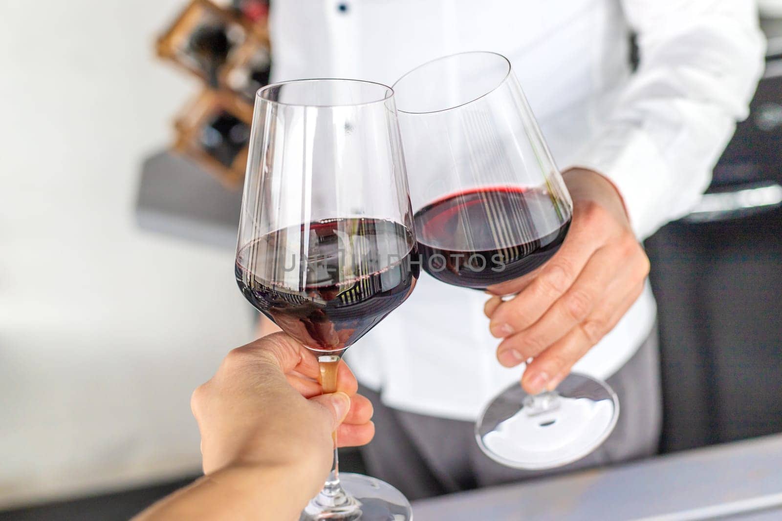Glass of red wine in hands. Selective focus. drink.