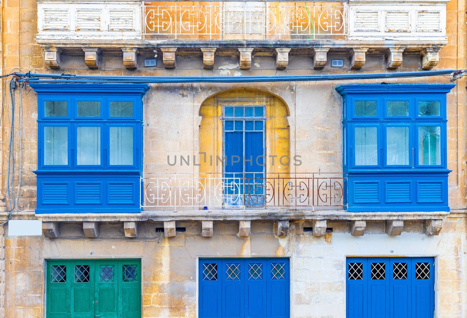 Facade of a residential building with traditional Maltese balconies, Valletta, Malta.