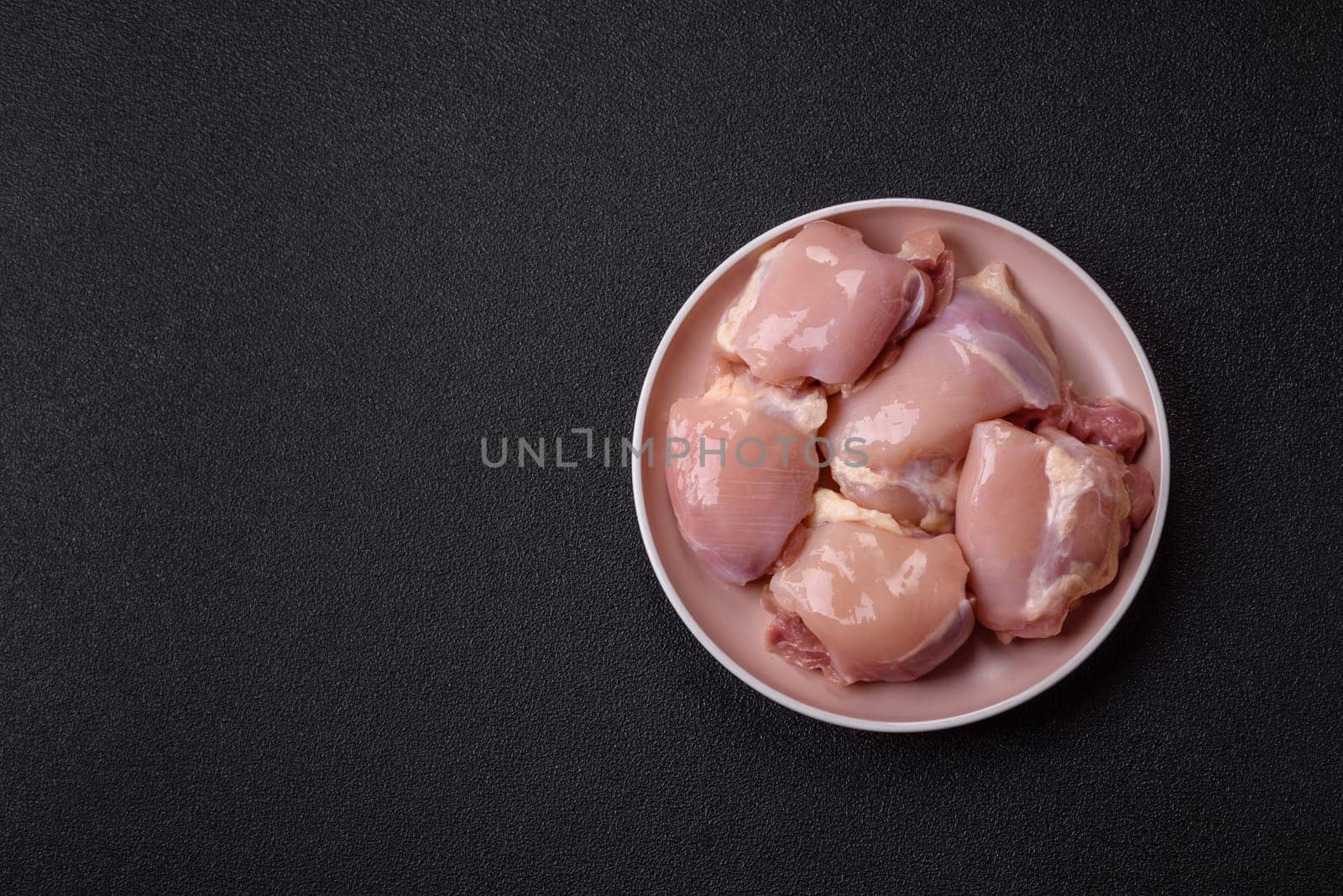 Chicken thigh fillet raw, skinless, boneless, poultry legs with salt and spices