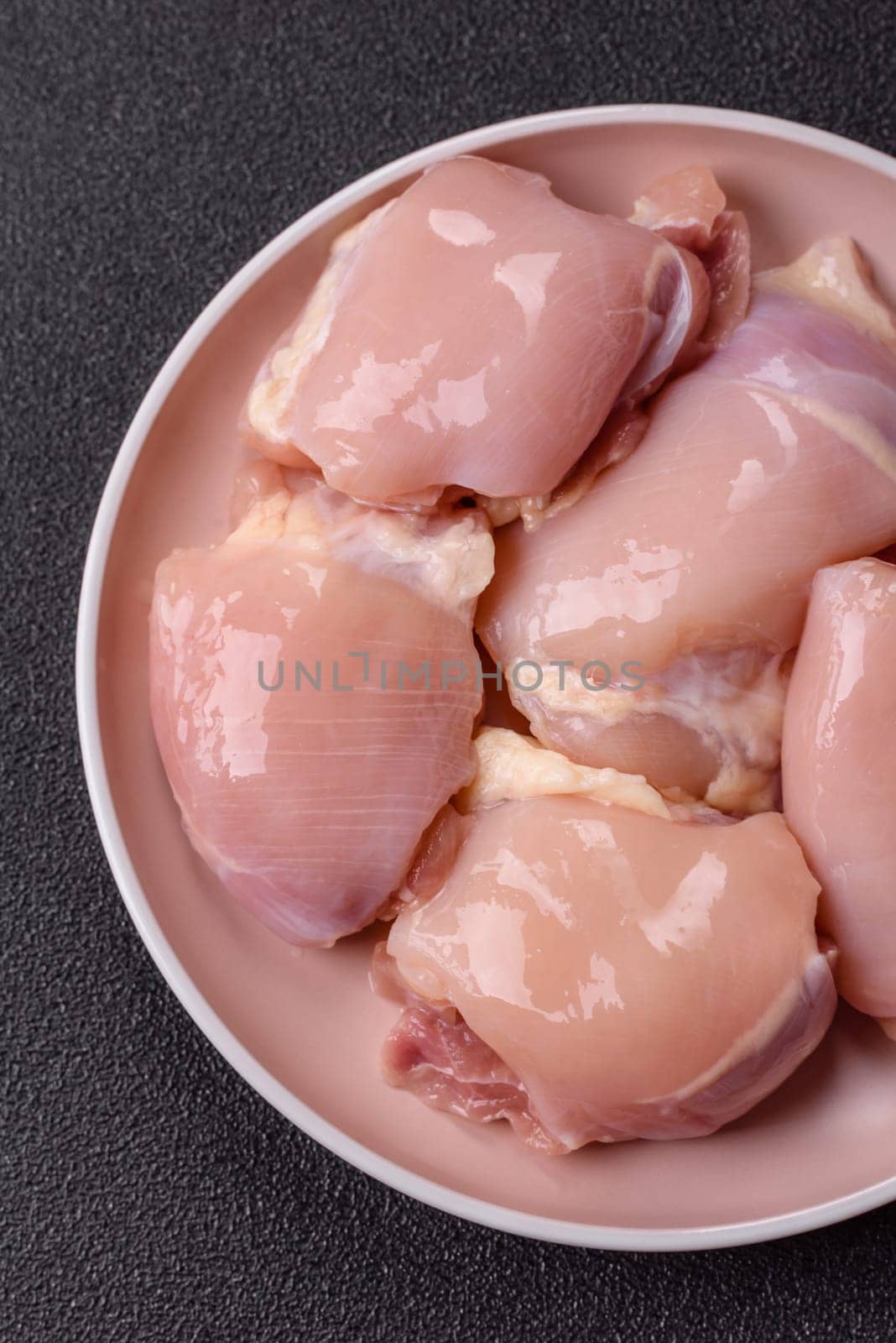 Chicken thigh fillet raw, skinless, boneless, poultry legs with salt and spices
