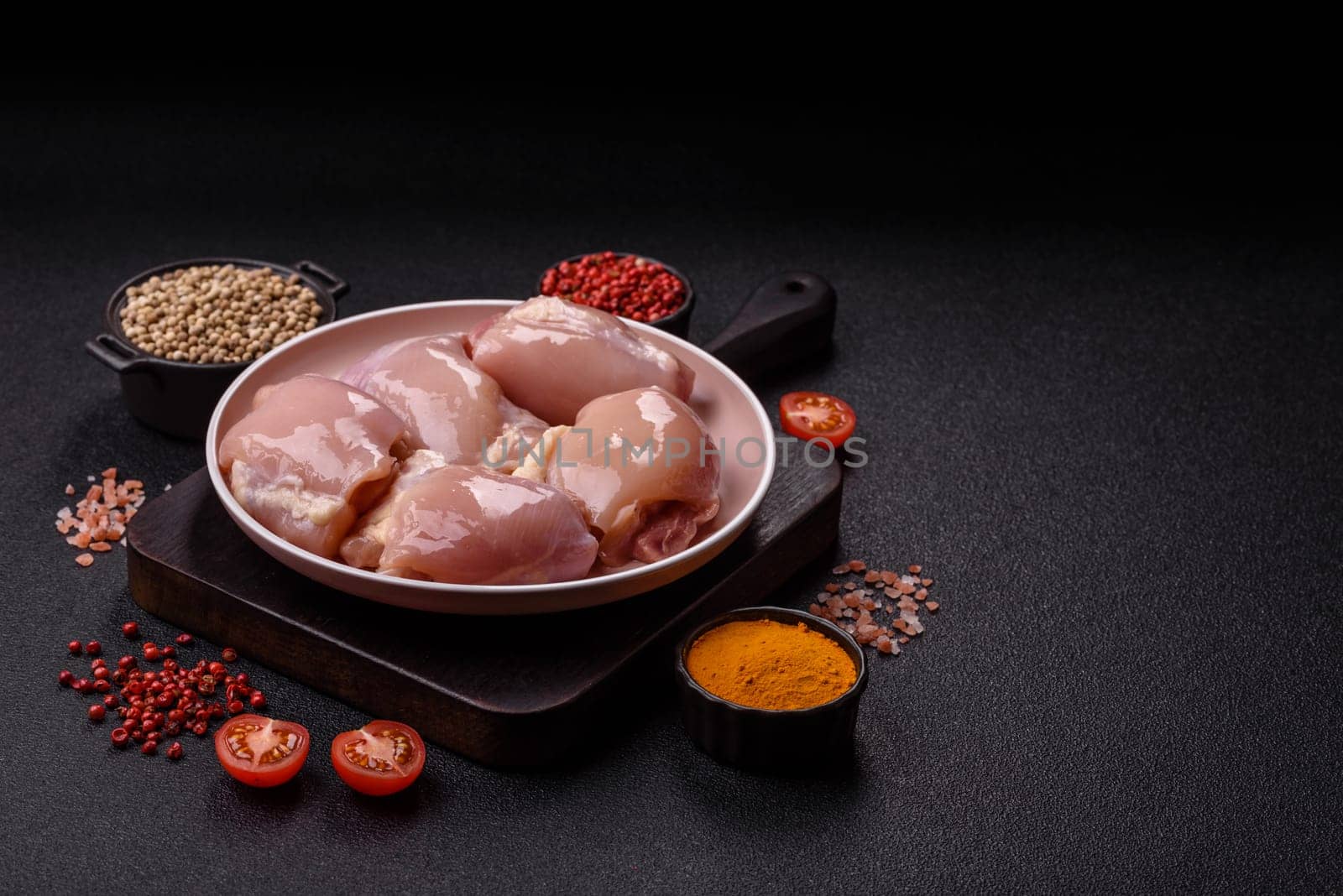 Chicken thigh fillet raw, skinless, boneless, poultry legs with salt and spices