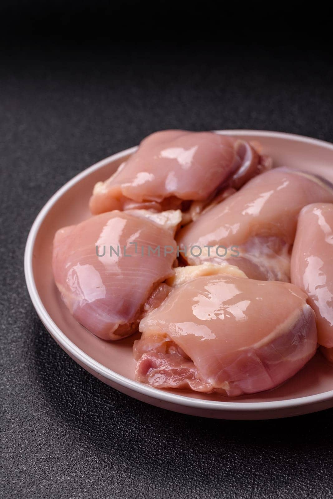 Chicken thigh fillet raw, skinless, boneless, poultry legs with salt and spices