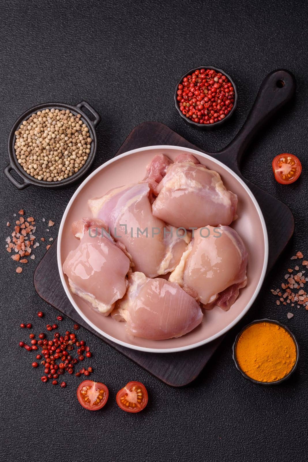 Chicken thigh fillet raw, skinless, boneless, poultry legs with salt and spices