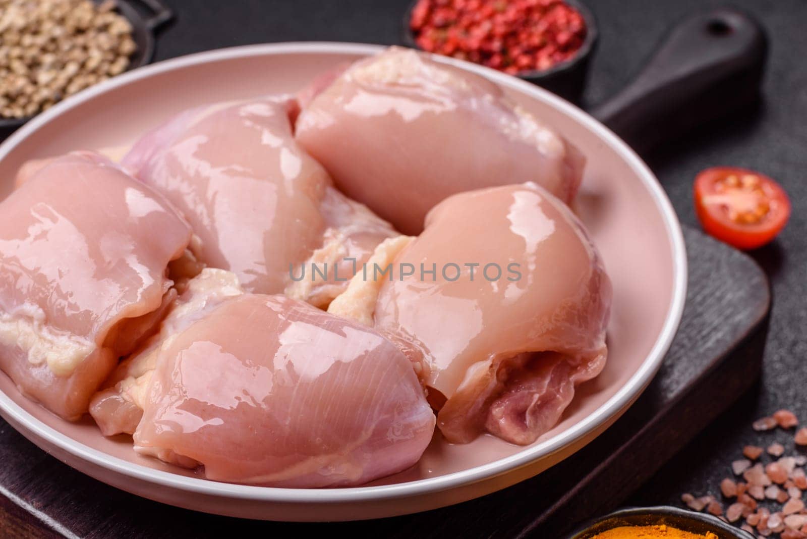 Chicken thigh fillet raw, skinless, boneless, poultry legs with salt and spices