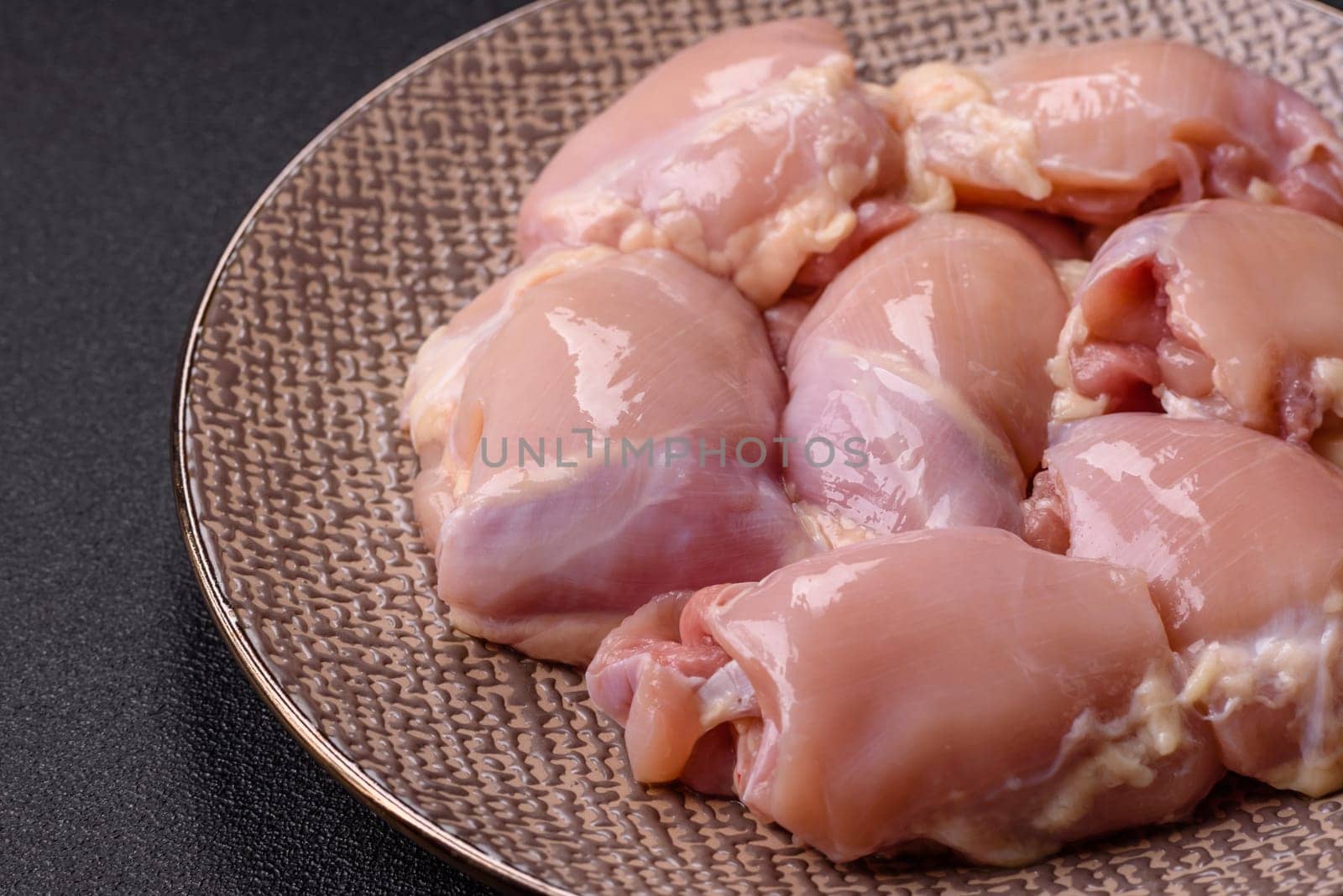 Chicken thigh fillet raw, skinless, boneless, poultry legs with salt and spices