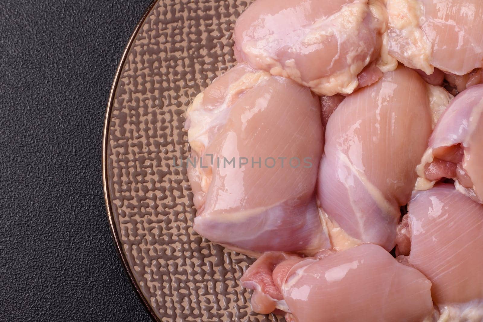 Chicken thigh fillet raw, skinless, boneless, poultry legs with salt and spices