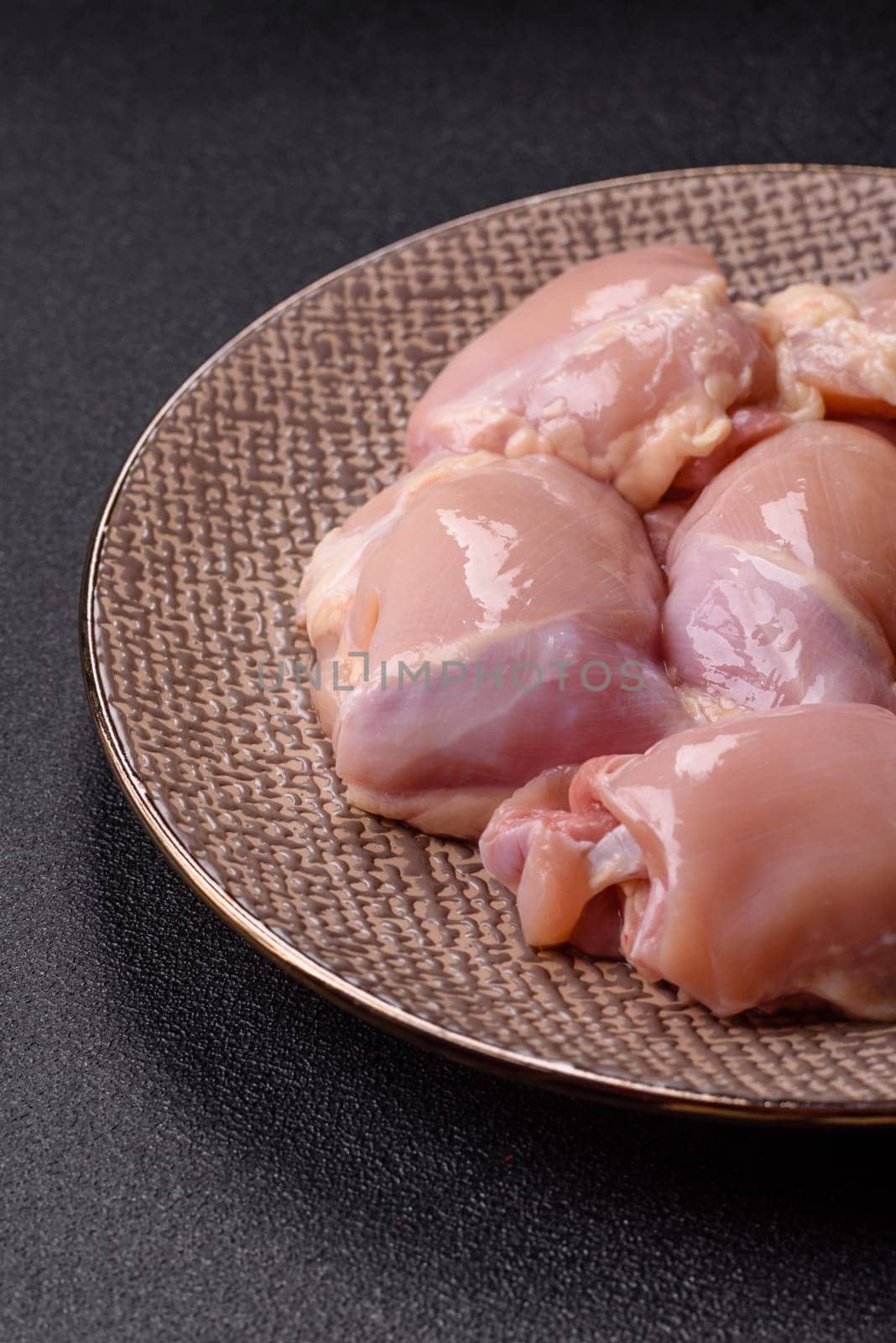 Chicken thigh fillet raw, skinless, boneless, poultry legs with salt and spices